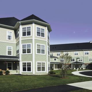 A modern residential building with multiple stories and a well-maintained exterior.