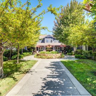 Beautiful residential home surrounded by lush trees and a well-maintained garden.