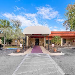 A charming entrance to a well-designed building against a bright blue sky.