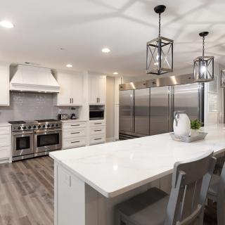 A spacious modern kitchen with a central island and sleek appliances.