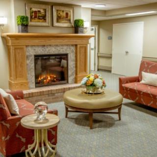 A cozy living room with a fireplace and comfortable seating.