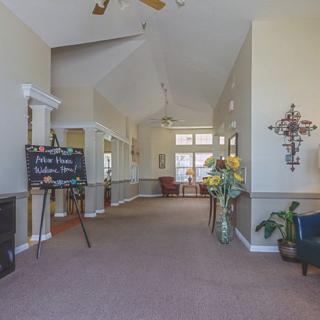 A spacious and well-decorated lobby area with seating and plants.