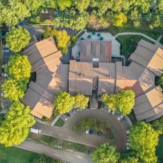 Aerial view of a building surrounded by lush greenery.