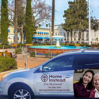 A Home Instead vehicle parked near a community area, promoting home care services.