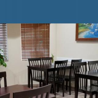 A cozy indoor dining area with wooden tables and chairs.