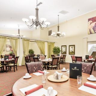 Elegant dining room with neatly arranged tables and soft lighting.