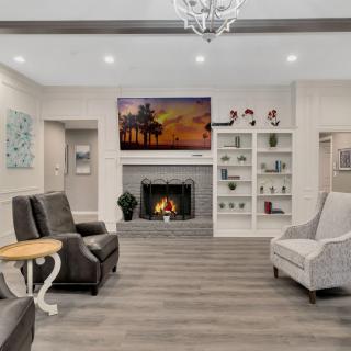 A modern living room with a cozy fireplace and elegant seating arrangement.