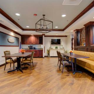 Modern dining area with wooden floors and contemporary furnishings.
