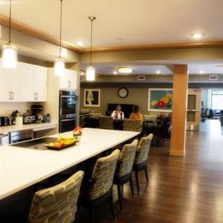 A modern open-concept kitchen and dining area with contemporary furnishings and bright lighting.