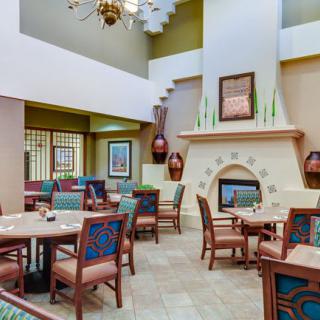 A cozy dining area featuring a fireplace and stylish seating arrangements.
