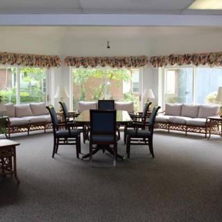 A bright lounge area with seating and large windows.