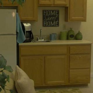 A cozy kitchen corner with wooden cabinets and homey decor.