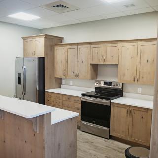 A modern kitchen with wooden cabinets and stainless steel appliances.
