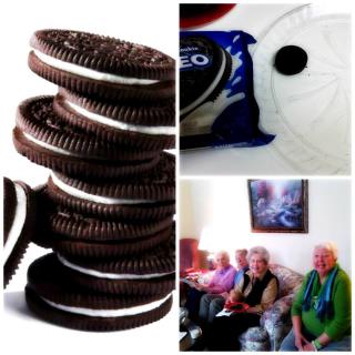 A stack of Oreo cookies alongside a group of elderly people sitting in a living room.