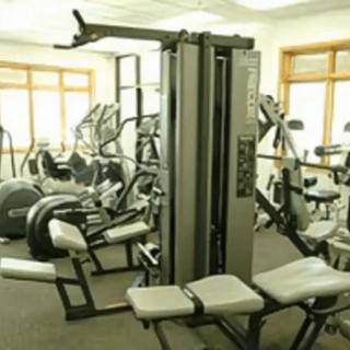A gym room filled with various exercise equipment.