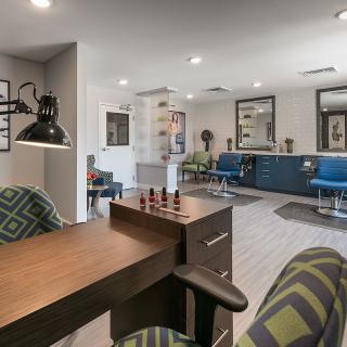 A modern salon interior with stylish furniture and bright lighting.