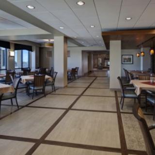 A spacious and elegantly designed restaurant dining area with neatly arranged tables and chairs.