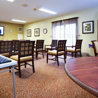 A small waiting room with arranged chairs and wall decor.