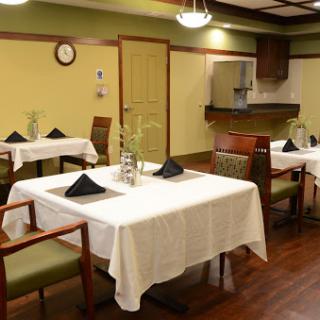 A cozy dining area set up with neatly arranged tables and chairs, ready for guests.