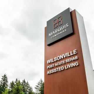 A tall sign for Marquis Wilsonville Post Acute Rehab and Assisted Living.