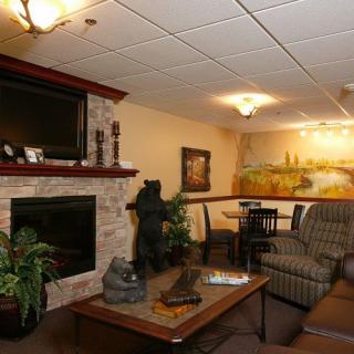 A cozy living room with a fireplace, television, and comfortable seating.
