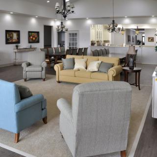 A modern, open-plan living room with various seating options and stylish lighting.