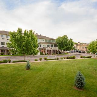 A peaceful suburban neighborhood with neatly maintained lawns and trees.