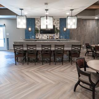 A modern bar area with seating and stylish lighting.