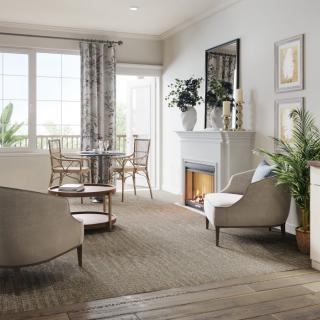 A cozy living room with modern decor, featuring a fireplace and a bright dining area.