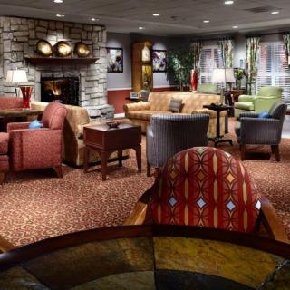 A cozy hotel lobby with comfortable seating and warm lighting.