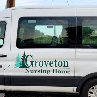 A van labeled 'Groveton Nursing Home' used for transportation.