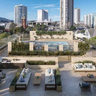 A modern rooftop terrace featuring a pool, surrounded by high-rise buildings in an urban skyline.