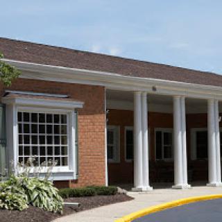 A well-constructed building featuring brick walls and elegant columns.