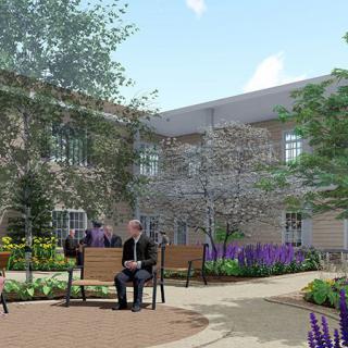 A peaceful courtyard with benches, trees, and flowers where people can relax.
