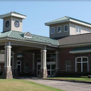 A modern building featuring a clock tower, characterized by its stylish architecture and well-maintained exterior.