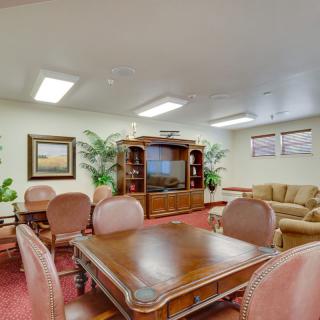 A cozy living room with comfortable seating and a large television.
