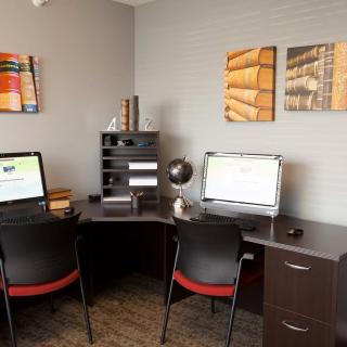 A modern office workspace with two computer stations and stylish decor.
