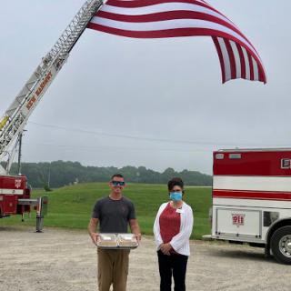 A community celebration under the American flag with local heroes.