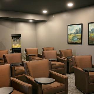 A modern waiting room with comfortable chairs and calming artwork.