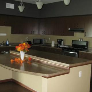 A modern kitchen with a spacious countertop and various appliances.