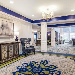 A well-lit lobby area featuring elegant furniture and decorative elements.