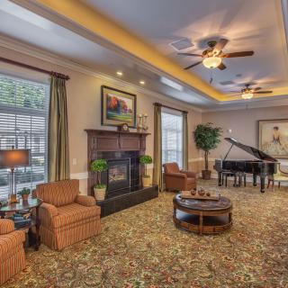 Elegant living room with a cozy fireplace and grand piano.