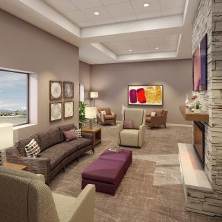 A modern living room with stylish furniture, a cozy fireplace, and contemporary artwork.
