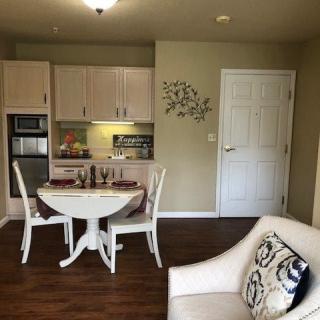 A cozy kitchen and dining area with white cabinetry and a round dining table.