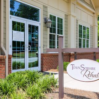 The entrance of a professional building featuring a sign for 'Trans Square Realty'.