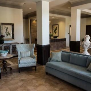A stylish lobby with comfortable seating, elegant artwork, and decor.