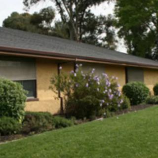 A suburban house with a well-maintained lawn and garden.