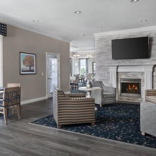 A modern living room featuring sleek furniture and a cozy fireplace.