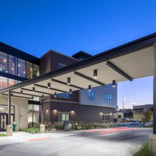 A modern healthcare facility illuminated at night.