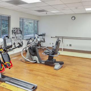 A well-equipped indoor gym with various exercise machines.